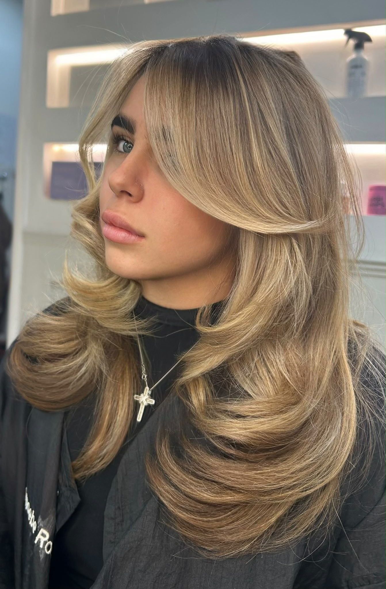 Bouncy layered blow dry with soft face framing